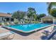 Relaxing community pool area with mature trees and plenty of seating for residents at 3208 Vivienda Blvd, Bradenton, FL 34207