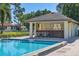 View of the community pool and the pool house featuring a bar and seating at 3208 Vivienda Blvd, Bradenton, FL 34207