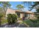 A spacious backyard, featuring lush greenery, shade trees, and the home's exterior at 3296 Tallywood Ct # 7097, Sarasota, FL 34237
