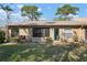 Well-maintained lawn, some shrubbery, and exterior doors enhance this cozy backyard space at 3296 Tallywood Ct # 7097, Sarasota, FL 34237