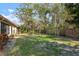 A large backyard with a green lawn, mature trees, and a tidy perimeter fence at 3296 Tallywood Ct # 7097, Sarasota, FL 34237