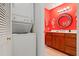 Bathroom and laundry featuring cherry cabinets and an eye-catching seahorse mirror at 3296 Tallywood Ct # 7097, Sarasota, FL 34237