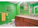 Bathroom with double vanity, green walls, decorative artwork, and great lighting at 3296 Tallywood Ct # 7097, Sarasota, FL 34237