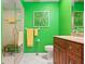 This is a bright bathroom with yellow walls and a glass-enclosed shower at 3296 Tallywood Ct # 7097, Sarasota, FL 34237