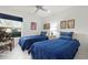 Bright bedroom with two twin beds, ceiling fan, and whimsical circus posters at 3296 Tallywood Ct # 7097, Sarasota, FL 34237