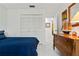 Bedroom with a full bed, dresser, white closet and tile floor at 3296 Tallywood Ct # 7097, Sarasota, FL 34237