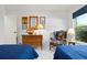 Comfortable bedroom with two twin beds, dresser, nautical decor, and a window at 3296 Tallywood Ct # 7097, Sarasota, FL 34237