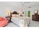 Light bedroom features ceiling fan, patterned bedspread, and matching nightstands at 3296 Tallywood Ct # 7097, Sarasota, FL 34237