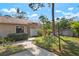 Inviting single-story home featuring a well-maintained lawn, garden bed and sidewalk leading to the front entrance at 3296 Tallywood Ct # 7097, Sarasota, FL 34237