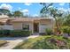 Charming one-story home with a well-kept lawn, garden, and inviting walkway leading to the front door at 3296 Tallywood Ct # 7097, Sarasota, FL 34237
