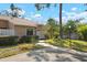 Charming home exterior with landscaped front yard, lush hedges, and a well-lit walkway at 3296 Tallywood Ct # 7097, Sarasota, FL 34237