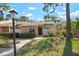 Charming exterior showcasing the manicured front lawn, walkway, and decorative touches around the entryway at 3296 Tallywood Ct # 7097, Sarasota, FL 34237