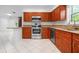 This kitchen has wood cabinets, granite countertops, and stainless steel appliances at 3296 Tallywood Ct # 7097, Sarasota, FL 34237