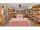 Cozy library with floor-to-ceiling bookshelves, a ceiling fan and comfortable seating at 3296 Tallywood Ct # 7097, Sarasota, FL 34237