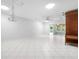 Bright living room featuring tile flooring, modern chandelier, and sliding glass doors to an enclosed lanai at 3296 Tallywood Ct # 7097, Sarasota, FL 34237