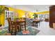 Bright, open-concept area combining the living and dining spaces with tropical decor and comfortable seating at 3296 Tallywood Ct # 7097, Sarasota, FL 34237
