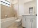 Bathroom showcasing a tiled shower, a window, a tub, and a vanity with quartz countertops at 3603 Night Star Terrace, Parrish, FL 34219