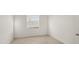 Bright bedroom with tile floors, a window, and access to a hallway through a white door at 3603 Night Star Terrace, Parrish, FL 34219