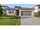 Charming single-story home boasts a well-manicured lawn, lovely landscaping, and a two-car garage at 3603 Night Star Terrace, Parrish, FL 34219