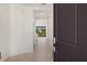 View through the open front door of the home's light-filled hallway leading to the living spaces at 3603 Night Star Terrace, Parrish, FL 34219