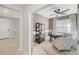Bright home office featuring a ceiling fan, large window, a neutral color palette, and comfortable armchairs at 3603 Night Star Terrace, Parrish, FL 34219
