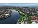 Aerial view of a golf course and lake homes in a community at 3617 Fair Oaks Pl, Longboat Key, FL 34228