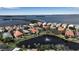 Aerial view of homes surrounding a pond with fountain at 3617 Fair Oaks Pl, Longboat Key, FL 34228