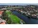 Aerial view of community with waterfront homes and golf course at 3617 Fair Oaks Pl, Longboat Key, FL 34228