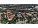 Aerial view of homes surrounding a pond in a community at 3617 Fair Oaks Pl, Longboat Key, FL 34228
