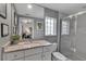Bathroom features a large vanity with stone countertops and a glass-enclosed shower at 3617 Fair Oaks Pl, Longboat Key, FL 34228