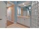 Bathroom view featuring a white vanity with granite countertop and glass block shower at 3617 Fair Oaks Pl, Longboat Key, FL 34228