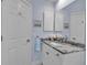 Bright bathroom features a granite countertop, white cabinets, and decorative nautical accents at 3617 Fair Oaks Pl, Longboat Key, FL 34228