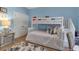 Bedroom with a bunk bed, a blue accent wall, hardwood floors and closet at 3617 Fair Oaks Pl, Longboat Key, FL 34228