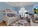 Bedroom with a bunk bed, a blue accent wall, and a hardwood floor at 3617 Fair Oaks Pl, Longboat Key, FL 34228