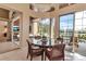Inviting breakfast nook featuring a glass table with views of the pool and outdoor living area at 3617 Fair Oaks Pl, Longboat Key, FL 34228