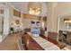 Formal dining room boasts stylish furnishings, a decorative chandelier, and serene views into the adjacent living area at 3617 Fair Oaks Pl, Longboat Key, FL 34228