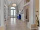 Bright foyer features decorative mirror, chandelier, and tiled flooring at 3617 Fair Oaks Pl, Longboat Key, FL 34228
