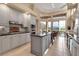 Modern kitchen featuring stainless steel appliances, granite countertops, a center island, and access to the outdoor patio at 3617 Fair Oaks Pl, Longboat Key, FL 34228