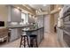 Spacious kitchen featuring gray cabinets, dark granite countertops, and a large island with seating at 3617 Fair Oaks Pl, Longboat Key, FL 34228