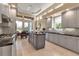 Well-equipped kitchen features stainless steel appliances, granite countertops, a center island, and access to the outdoor patio at 3617 Fair Oaks Pl, Longboat Key, FL 34228