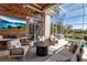 Covered lanai with wood paneling, comfortable seating, and views of the lake and pool at 3617 Fair Oaks Pl, Longboat Key, FL 34228