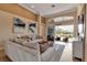 Bright living room featuring high ceilings, neutral tones, elegant decor, and expansive windows to the outdoor living space at 3617 Fair Oaks Pl, Longboat Key, FL 34228