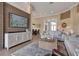 Bright living room featuring a TV wall, comfortable seating, and seamless transition to the dining area at 3617 Fair Oaks Pl, Longboat Key, FL 34228