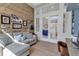 Comfortable office area with a rustic wooden wall, and view to the bathroom at 3617 Fair Oaks Pl, Longboat Key, FL 34228