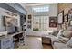 Office area with a large window, a gray sofa and hardwood floors at 3617 Fair Oaks Pl, Longboat Key, FL 34228