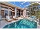 Outdoor pool area with covered patio and lounge seating at 3617 Fair Oaks Pl, Longboat Key, FL 34228