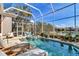 Screened pool and hot tub with sunny patio and view of the lake at 3617 Fair Oaks Pl, Longboat Key, FL 34228
