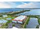 Aerial showcasing a condo community featuring water views, pool, docks, and convenient parking areas at 3805 E Bay Dr # 301, Holmes Beach, FL 34217