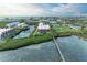 Waterfront condo complex with lush landscaping, and a charming wooden pier at 3805 E Bay Dr # 301, Holmes Beach, FL 34217