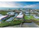 Stunning aerial view of condos nestled along scenic waterways with lush landscaping and community pool at 3805 E Bay Dr # 301, Holmes Beach, FL 34217
